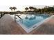 Community pool with a brick paver deck, swimming lanes, and lounge chairs at 3661 Kingswood Ct, Clermont, FL 34711