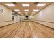 Large dance studio with hardwood floors, mirrored walls, and ceiling fans at 3661 Kingswood Ct, Clermont, FL 34711