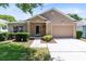 Inviting single-story home with manicured landscaping and a attached garage at 3661 Kingswood Ct, Clermont, FL 34711