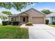 Charming single-story home with a well-manicured lawn and a two car garage at 3661 Kingswood Ct, Clermont, FL 34711
