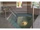 Relaxing hot tub in a tiled room with convenient handrails and bench seat at 3661 Kingswood Ct, Clermont, FL 34711
