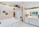 Bright kitchen with white cabinetry, modern appliances, and a window overlooking the yard at 3661 Kingswood Ct, Clermont, FL 34711
