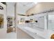 Bright kitchen with white cabinets, white appliances, and an open layout that seamlessly connects to other living spaces at 3661 Kingswood Ct, Clermont, FL 34711