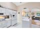 Kitchen view featuring ample counter space, white appliances, and an open design that flows to the living area at 3661 Kingswood Ct, Clermont, FL 34711