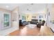 Spacious living room featuring natural light, wood floors, and an inviting atmosphere for relaxation and entertainment at 3661 Kingswood Ct, Clermont, FL 34711