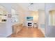 Bright living room featuring a fireplace, wood floors, and easy access to the kitchen through an open design at 3661 Kingswood Ct, Clermont, FL 34711