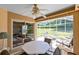 Inviting screened patio with a ceiling fan and stylish outdoor seating at 3661 Kingswood Ct, Clermont, FL 34711