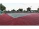 Well maintained tennis courts with new netting, surrounded by mature trees and fencing at 3661 Kingswood Ct, Clermont, FL 34711