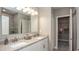 Spacious bathroom features double sinks, a granite countertop, and access to a walk-in closet at 3880 Bluethread Way, Poinciana, FL 34759