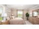 Comfortable bedroom with natural light, a large window, and neutral decor at 3880 Bluethread Way, Poinciana, FL 34759