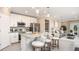 Modern kitchen with stainless steel appliances, granite countertops, and a breakfast bar at 3880 Bluethread Way, Poinciana, FL 34759