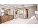 Serene main bedroom features a dresser with a mirror and neutral decor at 3880 Bluethread Way, Poinciana, FL 34759