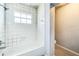 Bathroom with shower/tub combo and tiled walls at 409 Lake Ned Rd, Winter Haven, FL 33884