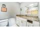 Bathroom features granite vanity and large mirror at 409 Lake Ned Rd, Winter Haven, FL 33884
