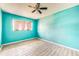 Bedroom features wood look tile flooring, ceiling fan and pink curtains at 409 Lake Ned Rd, Winter Haven, FL 33884