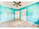 Vibrant bedroom with light tile floors, ceiling fan, and closet at 409 Lake Ned Rd, Winter Haven, FL 33884