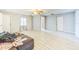 Spacious living room with tile floors, ceiling fan, and natural light streaming through the window at 409 Lake Ned Rd, Winter Haven, FL 33884