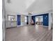 Spacious living room with new flooring and ceiling fan leading to another room at 409 Lake Ned Rd, Winter Haven, FL 33884