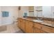 Bathroom featuring double sinks, granite countertops, and a shower-tub combination at 411 Terrace Ridge Cir # 222, Davenport, FL 33896