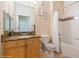 Well-lit bathroom with a granite countertop, bathtub, and neutral tile at 411 Terrace Ridge Cir # 222, Davenport, FL 33896
