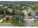 Aerial view of a home in a tree-filled neighborhood with well-manicured lawns at 4118 Teriwood Ave, Orlando, FL 32812