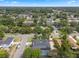 Aerial view of a home with screened-in pool, dark roof, and mature landscaping at 4118 Teriwood Ave, Orlando, FL 32812