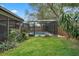 Fenced backyard with a screened pool area at 4118 Teriwood Ave, Orlando, FL 32812
