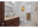 A bathroom with a stained wood vanity, standard toilet, neutral walls, and a shower with a curtain at 4118 Teriwood Ave, Orlando, FL 32812