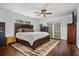 A primary bedroom featuring dark wood flooring, a ceiling fan, and a sliding glass door for natural light at 4118 Teriwood Ave, Orlando, FL 32812