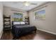A simple bedroom featuring hardwood floors, a dark comforter and neutral-toned walls for a relaxing atmosphere at 4118 Teriwood Ave, Orlando, FL 32812