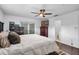 A well-lit bedroom featuring sleek, dark wood floors and modern, neutral decor with a ceiling fan overhead at 4118 Teriwood Ave, Orlando, FL 32812