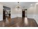Formal dining room featuring dark wood floors, modern lighting, and an open view of the front entrance at 4118 Teriwood Ave, Orlando, FL 32812