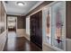 Home entryway featuring hardwood floors, a decorative glass window, and a view into the kitchen at 4118 Teriwood Ave, Orlando, FL 32812