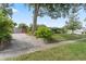 Charming single-story home with lush landscaping, a stone retaining wall, and a concrete driveway at 4118 Teriwood Ave, Orlando, FL 32812