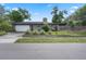 Charming single-story home with a well-manicured lawn, mature landscaping, and an attached garage at 4118 Teriwood Ave, Orlando, FL 32812