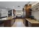 Spacious kitchen featuring granite countertops, dark wood cabinets, and stainless steel appliances at 4118 Teriwood Ave, Orlando, FL 32812