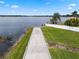 Beautiful lakefront with walkway leading to the water, offering a serene and picturesque setting with lush greenery at 4118 Teriwood Ave, Orlando, FL 32812