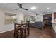 Bright living area showcases dark wood floors, a ceiling fan, a dining table, and access to the backyard at 4118 Teriwood Ave, Orlando, FL 32812