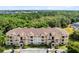 Wide aerial view of a condo building with lush surrounding greenery and ample parking at 422 Terrace Ridge Cir # 422, Davenport, FL 33896