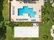 Aerial view of the community pool, lounge seating, and sand volleyball court at 422 Terrace Ridge Cir # 422, Davenport, FL 33896