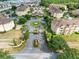 Overhead shot of a well-maintained condo community featuring lush landscaping and a central roundabout at 422 Terrace Ridge Cir # 422, Davenport, FL 33896