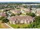 An aerial view shows a community with pools, manicured lawns, and residential buildings at 422 Terrace Ridge Cir # 422, Davenport, FL 33896
