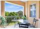 Relaxing balcony featuring outdoor seating and a view of the surrounding greenery and blue sky at 422 Terrace Ridge Cir # 422, Davenport, FL 33896