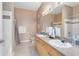 Bathroom featuring dual sinks, a vanity with storage, and a shower-tub combination at 422 Terrace Ridge Cir # 422, Davenport, FL 33896