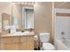 Bathroom features a vanity with a sink, mirror, toilet, and shower/tub combo at 422 Terrace Ridge Cir # 422, Davenport, FL 33896