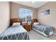 Bedroom featuring two twin beds, neutral walls and floors, and a large window with natural light at 422 Terrace Ridge Cir # 422, Davenport, FL 33896