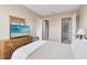 Bedroom featuring a wooden dresser and a glimpse into the en-suite bathroom and walk-in closet at 422 Terrace Ridge Cir # 422, Davenport, FL 33896