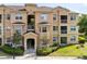Inviting exterior of a multi-story condo building with manicured landscaping and visible entrance walkways at 422 Terrace Ridge Cir # 422, Davenport, FL 33896