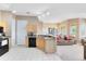 Open-concept kitchen with wood cabinets, tile flooring, and a view of the adjacent living area at 422 Terrace Ridge Cir # 422, Davenport, FL 33896