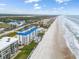 Aerial view of oceanfront condos and beachfront property on a sunny day with blue skies at 4601 S Atlantic Ave # 7030, Port Orange, FL 32127